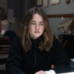 AmandaKnox GraceVanPatten.blacksweatshirt sitting